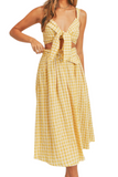 woman wearing a yellow gingham pattern set. Set is a cropped top that ties in the front with a midi skirt that has a belt 