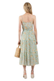 Mint colored floral spaghetto strap dress. Floral print has peach colored flowers, ruffled trim on top and tie belt