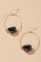 Gold wire hoop with a black agate stone in the middle 