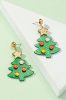 dangle Christmas tree earrings. Glittered acrylic Christmas tree shaped earrings. Tree is made if green glittered acrylic with circular ornaments that are red, gold and silver. There is a gold glittered star on top of the green that is attached to a circular gold earring post.  