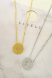 Gold and silver necklaces pictured on a jewelry card. Both necklaces have a dainty compass charm. Compass is a nautical medallion disk type of compass  