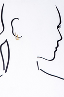 Rhinestone and gold double huggie hoop earring shown on a drawing profile of a woman 