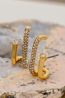 Gold and rhinestone double huggie stud earrings with a single rhinestone feature. Earrings have a post back. 