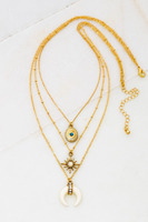 Three row gold chain necklace that is one necklace. Each layered chain has a different charms. Charms include a gold locket with a blue bead, a sun with a white stone center, and a white bullhorn with gold and gemstone detailing.
