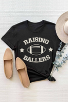 black unisex graphic t-shirt that says raising ballers with a football and 2 stars.  