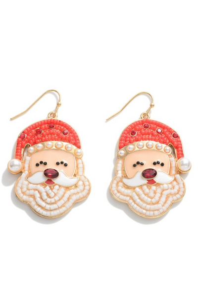 enamel Santa head earrings with beading details. Santa hat is beaded with red beads and red and white rhinestones. Pearl detailing on the rim and end of Santa's hat. Santa's beard is made out of white beads. Earrings have a gold fish hook 
