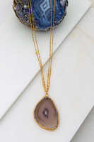 Tan agate pendant stone necklace on a gold double chain necklace